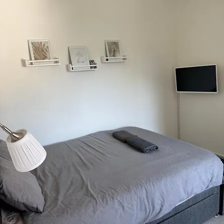 Bright Bedroom With King Side Bed And Share Bathroom
