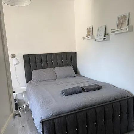 Bright Bedroom With King Side Bed And Share Bathroom