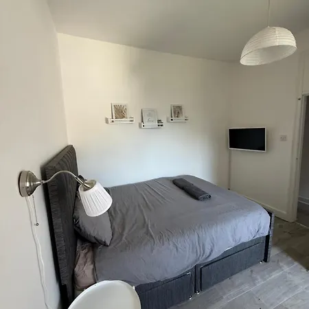 Bright Bedroom With King Side Bed And Share Bathroom