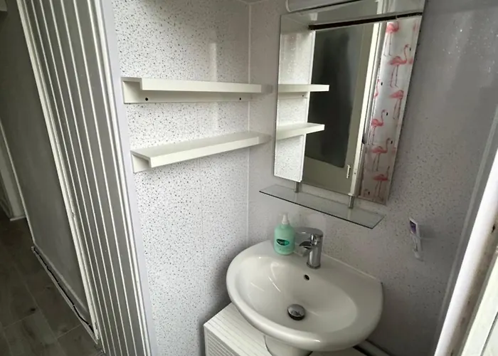 Bright Bedroom With King Side Bed And Share Bathroom