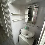 Bright Bedroom With King Side Bed And Share Bathroom